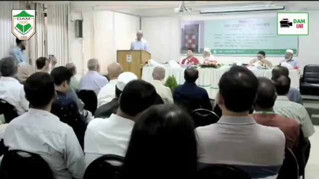 An audience seated in a hall during the discussion of the book Paraathaparater Anandadarshan