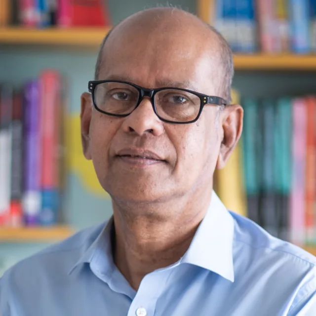 Khondokar Shakhawat Ali, portrait in front of a bookshelf